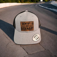 Thumbnail for I Identify as Non-Bidenary Leather Patch Trucker Hat Heather Grey/Black