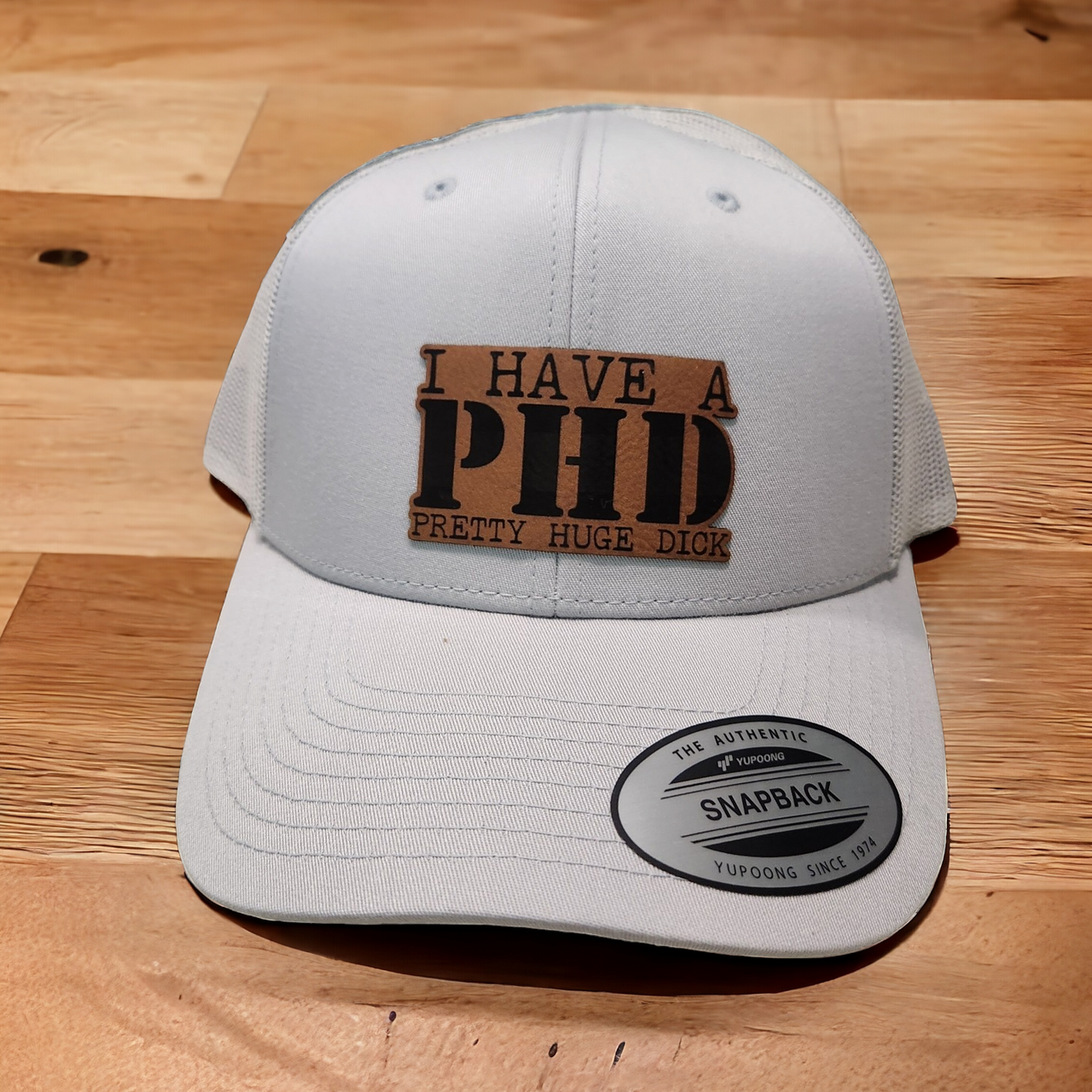 I Have a PhD (Pretty Huge Dick) Leather Patch Trucker Hat